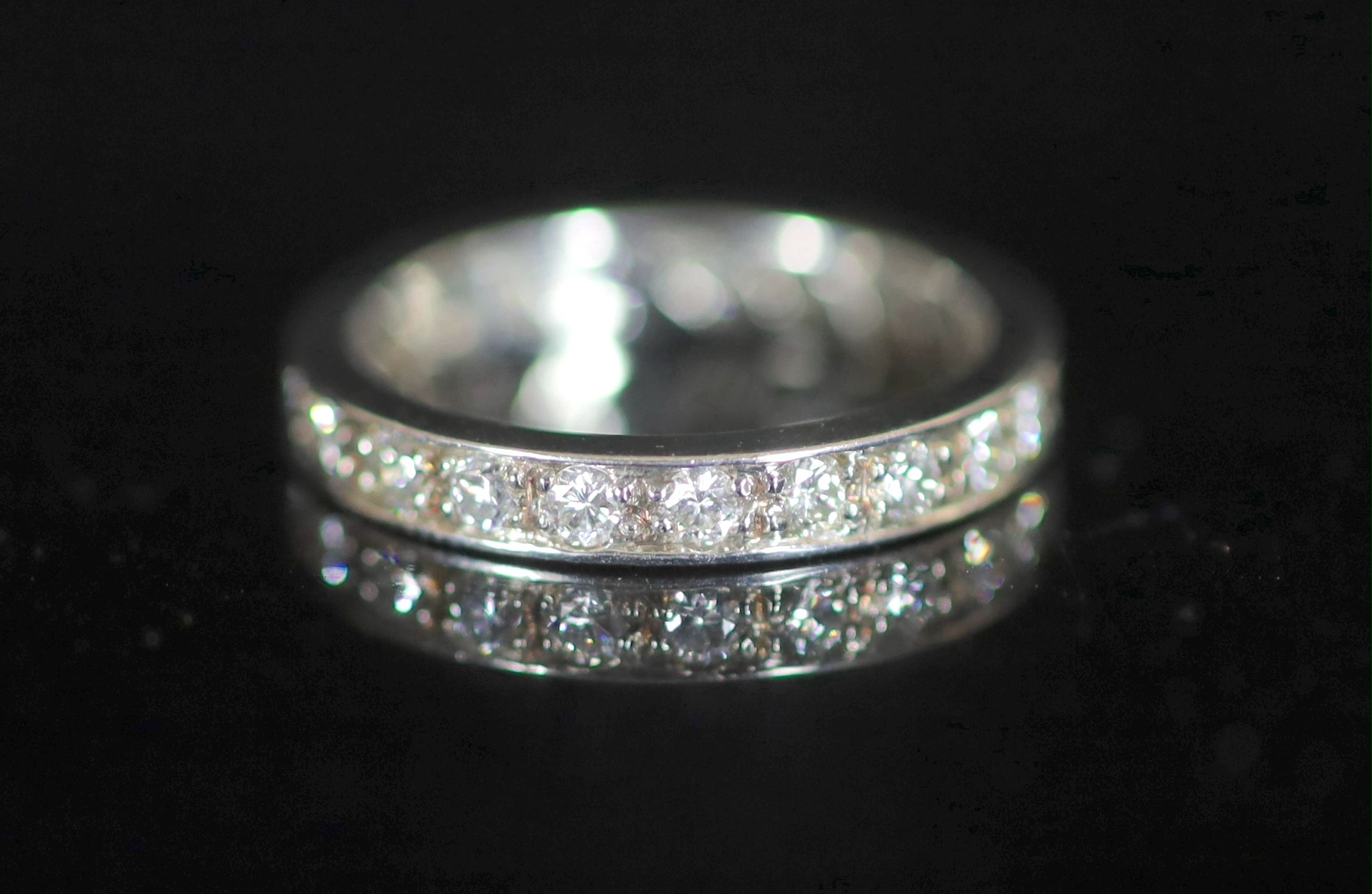 A mid to late 20th century platinum and diamond set full eternity ring